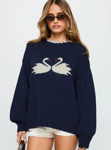 Detail of navy knit sweater featuring white swan jacquard and ribbed knit texture