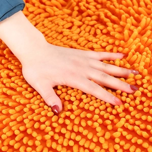 Plush heart-shaped orange chenille bath mat showing soft high-pile texture and absorbency