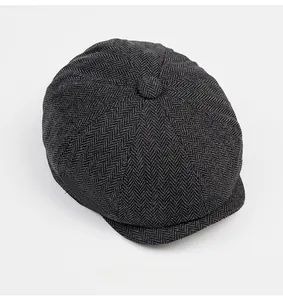 Top view of dark grey herringbone wool newsboy cap showing stitched panel construction