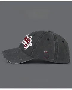 Detail of vintage gray baseball cap featuring red 1876 embroidery and distressed brim edge