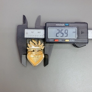 Digital caliper measuring the 25.9 mm width of the gold winged heart zircon ring