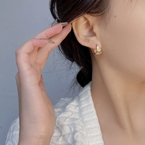 Minimalist gold S925 sterling silver hoop earrings with wave texture on model