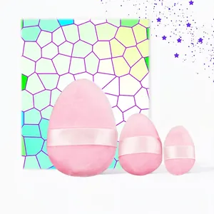Three-piece set of pink plush makeup puffs in different sizes with satin ribbon handles