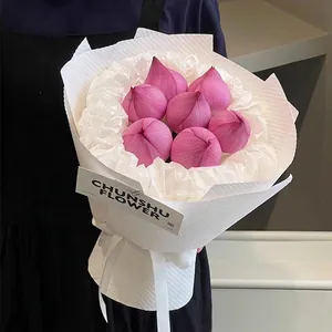 Pink lotus flower bouquet wrapped in white textured embossed 3D polka dot paper