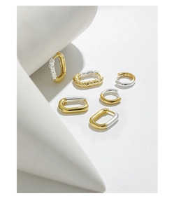 Detail view of S925 silver earrings with rock texture and mixed two-tone geometric design