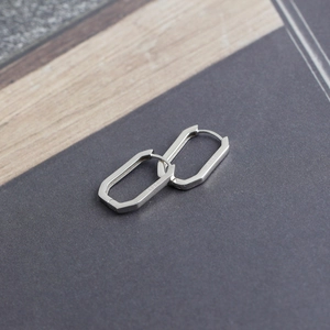Macro detail of S925 sterling silver rectangular earrings with visible engraved hallmark