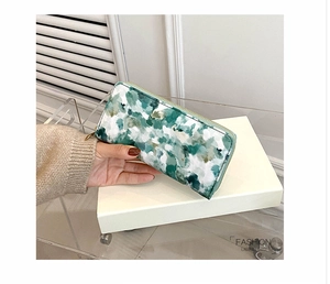 Detail of a green marble pattern long wallet with a premium gold zipper for women