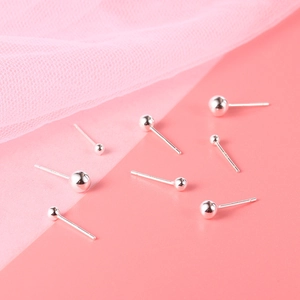 Minimalist S999 sterling silver ball stud earrings in various sizes on pink background