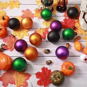 Halloween Christmas ball ornament set in matte black orange and green on wooden background