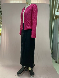 Detailed side view of sequin jacket with black maxi skirt on mannequin in studio