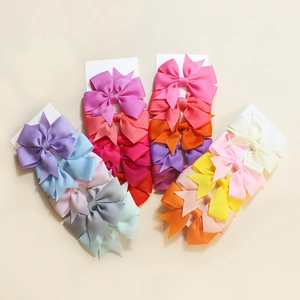 Set of colorful ribbed grosgrain ribbon bow hair clips on white display cards for girls