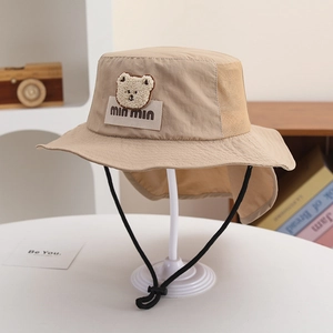 Detail showing beige sun hat breathable mesh fabric and adjustable windproof drawstring