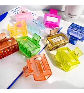 Collection of ten matte candy-colored square geometric hair claws in a flat lay view