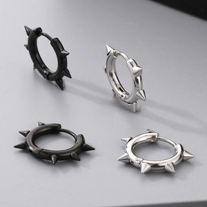 Close-up of punk style stainless steel spike hoop earrings in black and silver finishes