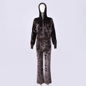 Detail of dark brown crushed velvet tracksuit featuring a zippered hoodie and matching pants