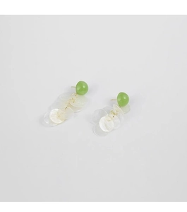 Detail view of shell fringe earrings with green studs and translucent shell discs