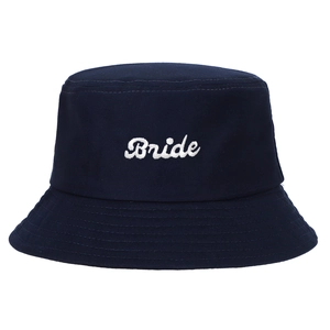 Detailed view of white Bride embroidery on a navy blue cotton bucket sun hat