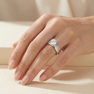 Detail view of silver titanium ring featuring six-prong cubic zirconia and pavé side stones