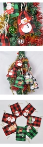 Close-up of festive plaid Christmas drawstring gift bags with cute animal patterns