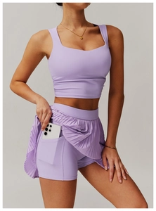 Detail view of athletic lilac skirt set featuring a functional side pocket for phone