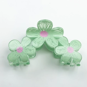 Cute green floral hair claw clip with pink centers in a candy-colored graffiti style