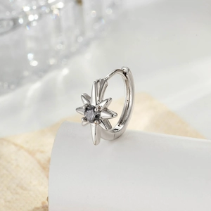 Star-shaped geometric silver hoop earring with dark grey zircon on white display