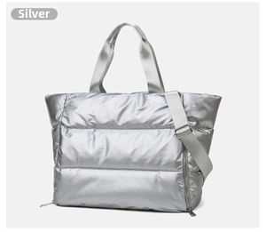 Detail of silver quilted gym bag showing metallic texture and adjustable shoulder strap