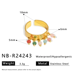 Detail of 18K gold stainless steel open ring with colorful beads and hammered texture