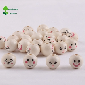 Detailed macro view of 20mm round wooden beads with various cute cartoon smiley face patterns