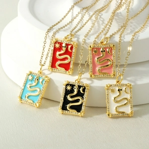 Detail of tarot necklaces with snake pendants in five colors on a tiered white stand