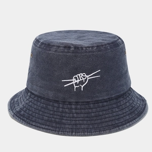 Detail of navy blue washed denim bucket hat with white embroidery and metal eyelets