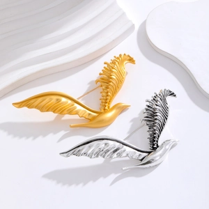 Elegant gold and silver eagle brooches featuring intricate feather textures for women