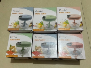 Manual food choppers in blue, green, and pink retail packaging on display