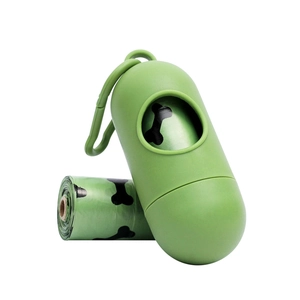 Green capsule dog poop bag dispenser with hook and a roll of bone pattern waste bags