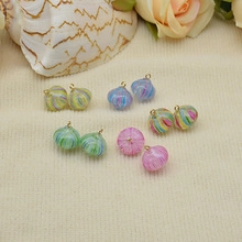 Macro view of pumpkin-shaped resin pendants in diverse pastel colors for DIY jewelry