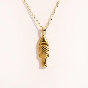 Detailed close-up of a 3D tropical fish pendant necklace in polished gold plating