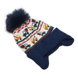 Detail of children's winter knit hat with colorful car patterns and large faux fur pom