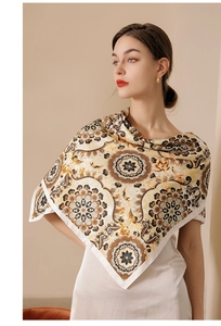 Detailed close-up of mandala flower pattern on silk scarf with white hemmed edges