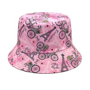 Pink cotton bucket hat with Paris Eiffel Tower and floral prints on a white background
