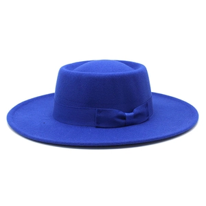 Close-up of royal blue wool felt boater hat featuring a matching grosgrain ribbon bow