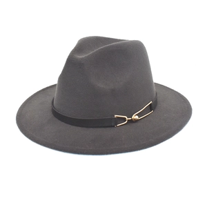 Detail view of dark grey wool fedora hat featuring a black band with a golden buckle