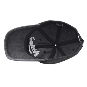 Detail view of cotton baseball cap interior featuring 100% cotton label and metal buckle