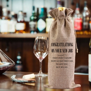 Brown burlap wine gift bag with drawstring and New Job congratulations text