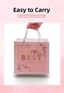 Pink paper gift bag with floral magnolia patterns and gold BEST WISHES lettering