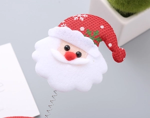 Detail shot of Santa Claus hair band with red non-woven fabric and silver metal spring