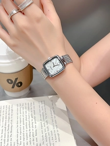 Close-up of a silver square quartz watch for women worn in a lifestyle setting
