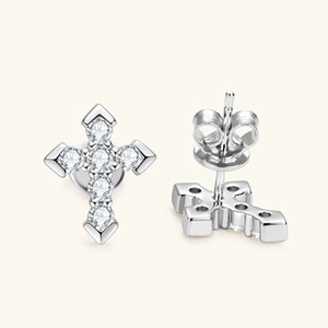 Macro detail of silver cross stud earrings set with clear zircon stones and butterfly back