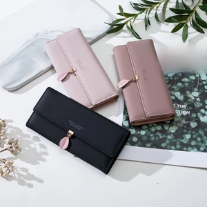 Detailed close-up of colorful PU leather wallets with leaf pendants and gold hardware