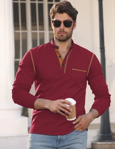 Outdoor shot of men's burgundy long sleeve polo with yellow contrast stitching detail