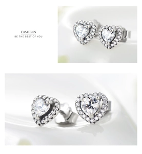 Detail of silver heart-shaped halo stud earrings with micro-pave cubic zirconia inlay